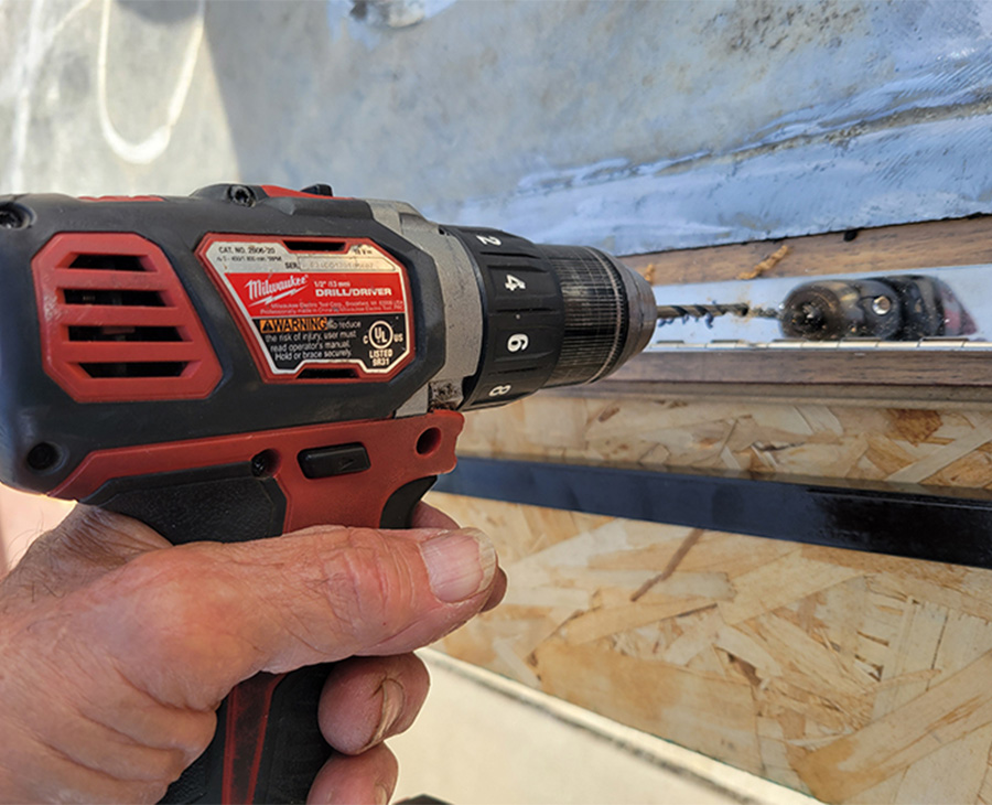 drill being used to create holes in the hinge