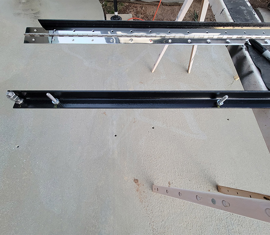 angle iron and hinge laying beside each other