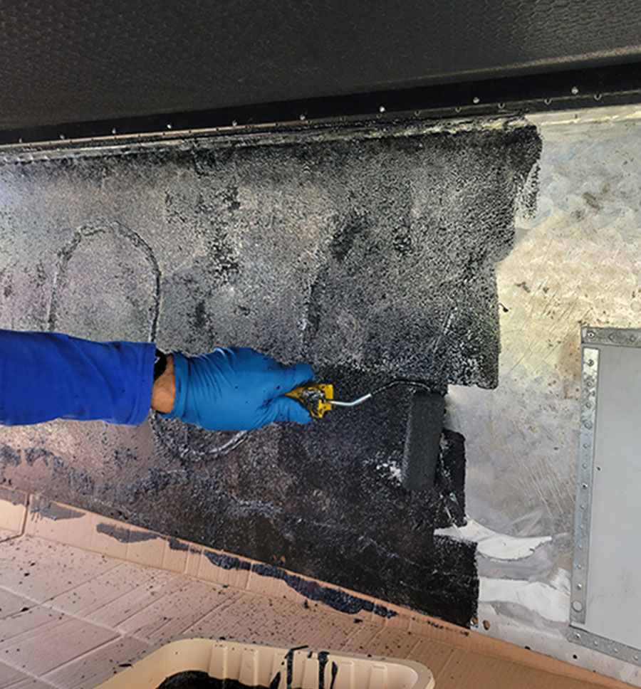 rubberized truck bed coating being applied to the diamond plate