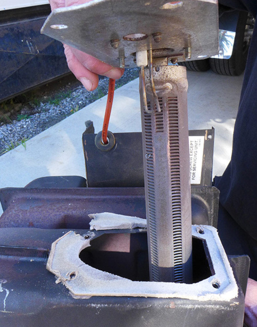 electrode placed in position above one of the slots in the burner assembly