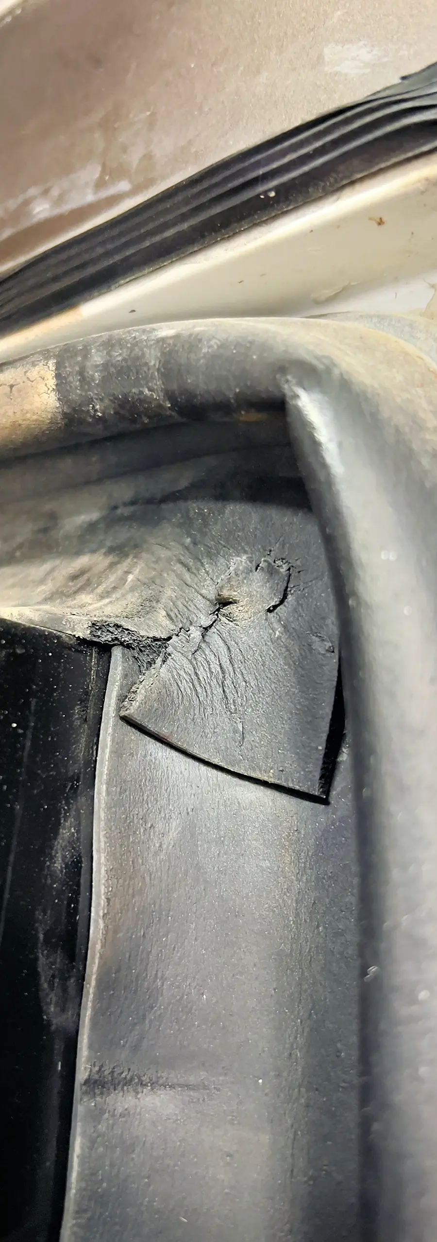 Portrait close-up photo view of a RV slide room wiper seal, which need to be inspected frequently because they can crack, tear and the corners come unglued, allowing an easy path for water to get inside the RV; They will last longer with frequent cleaning and treatment with a conditioner such as 303 Aerospace Protectant.