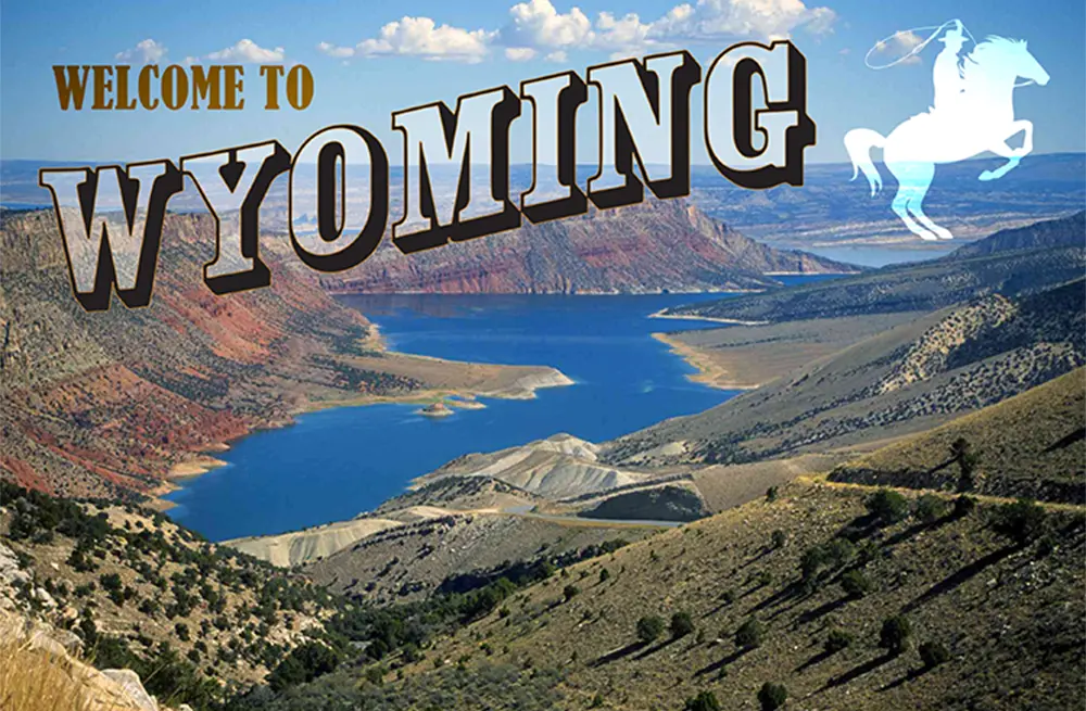 Welcome to Wyoming typography over an aerial shot of a valley lake