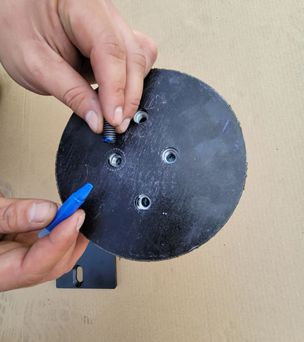 Allen set screw is coated with Loctite and screwed into top of the spring