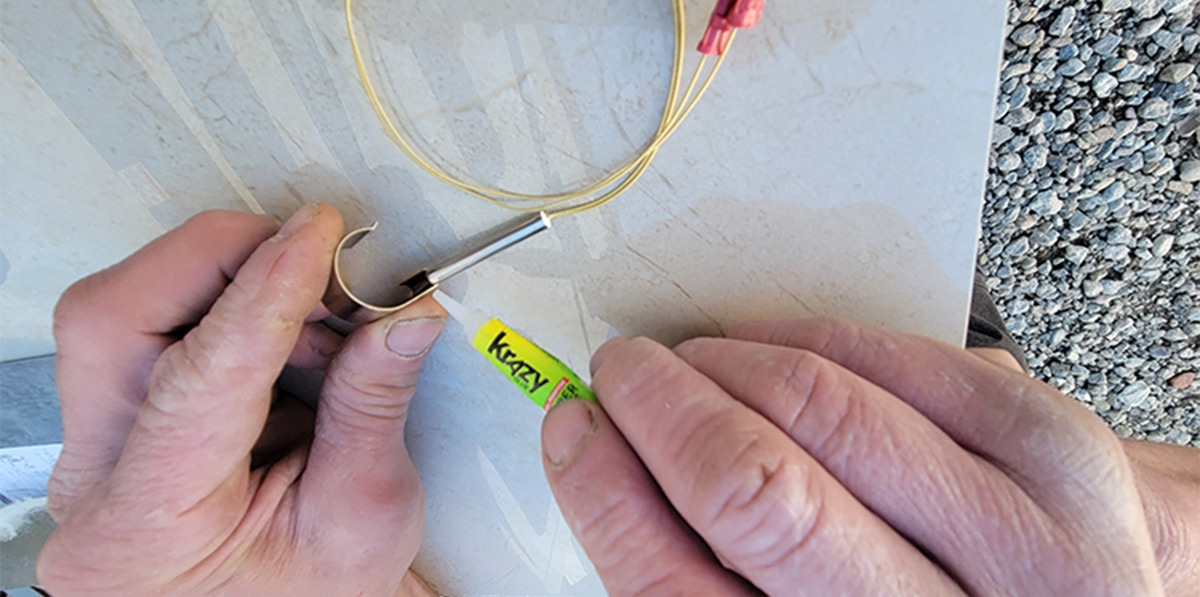 super glue being applied to the bracket
