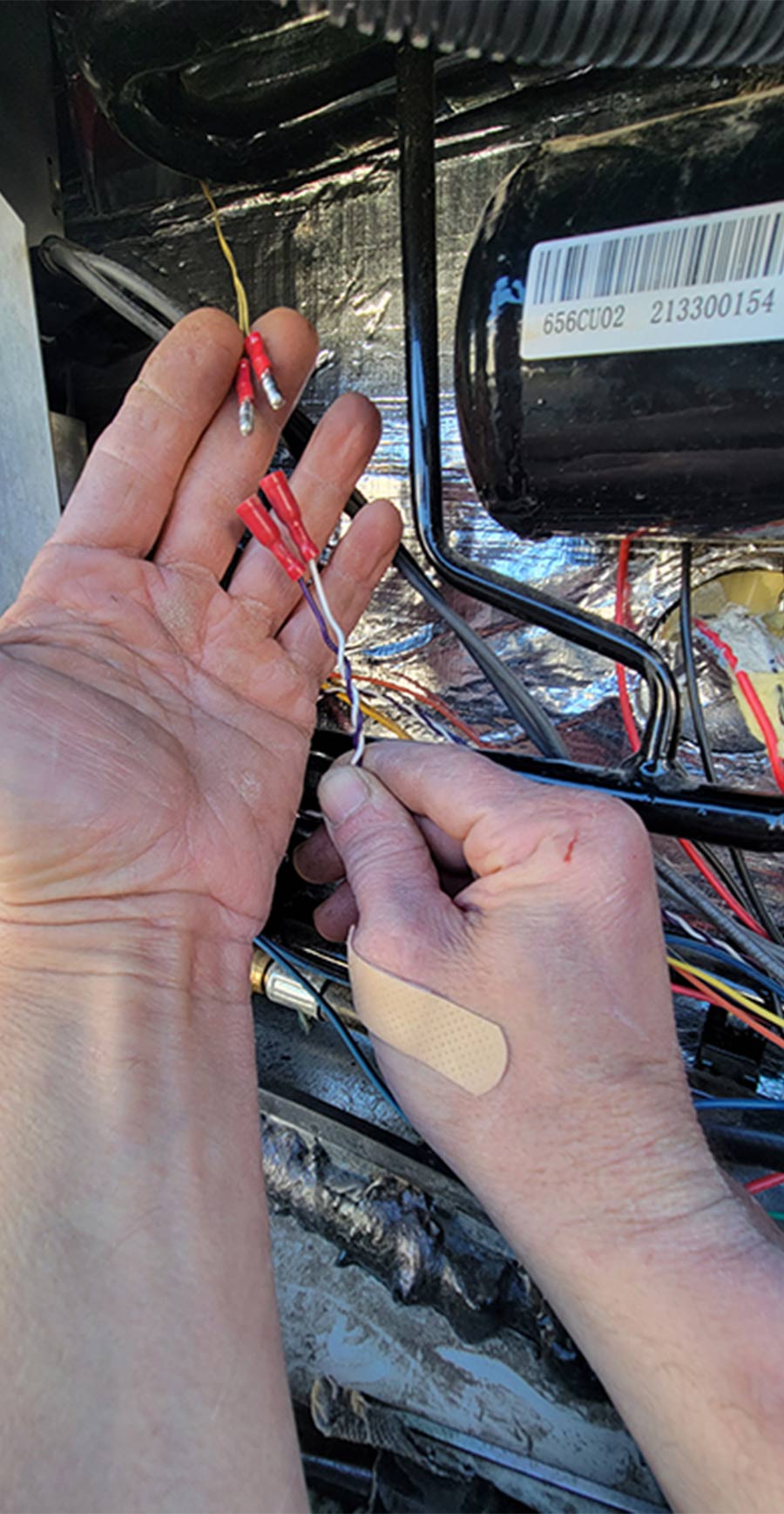 hands holding up the bullet connectors on the wires