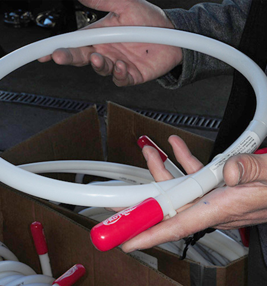 person holding up a coiled tube