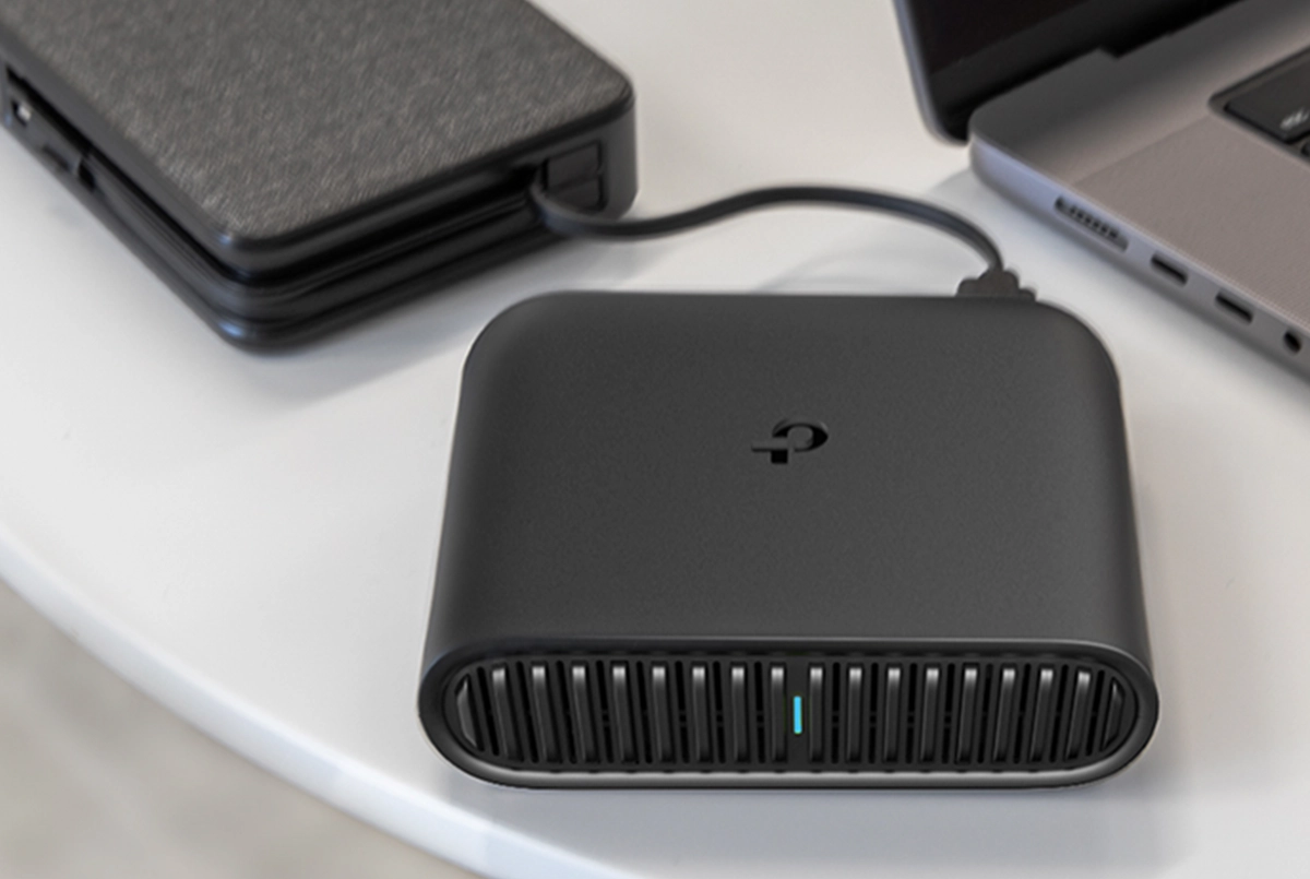 the pocket sized TP-Link router connected to a device cord