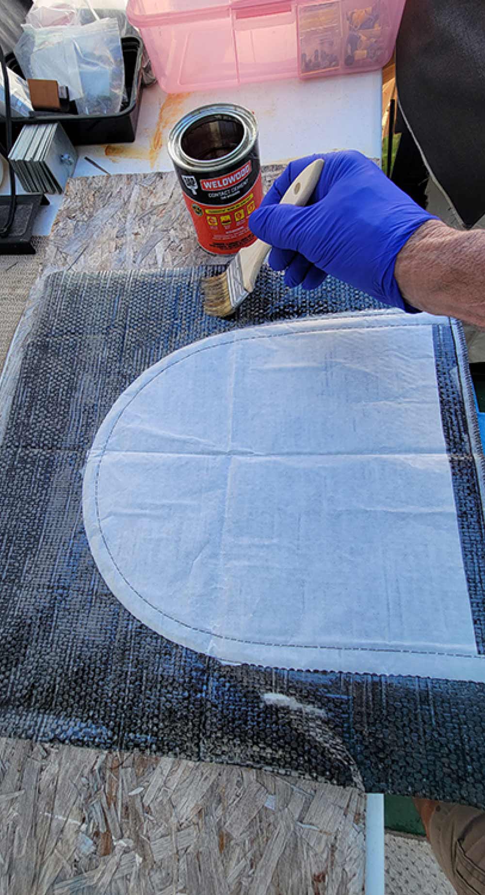 hand using a paint brush to apply a coat to a trap flap from Amazon