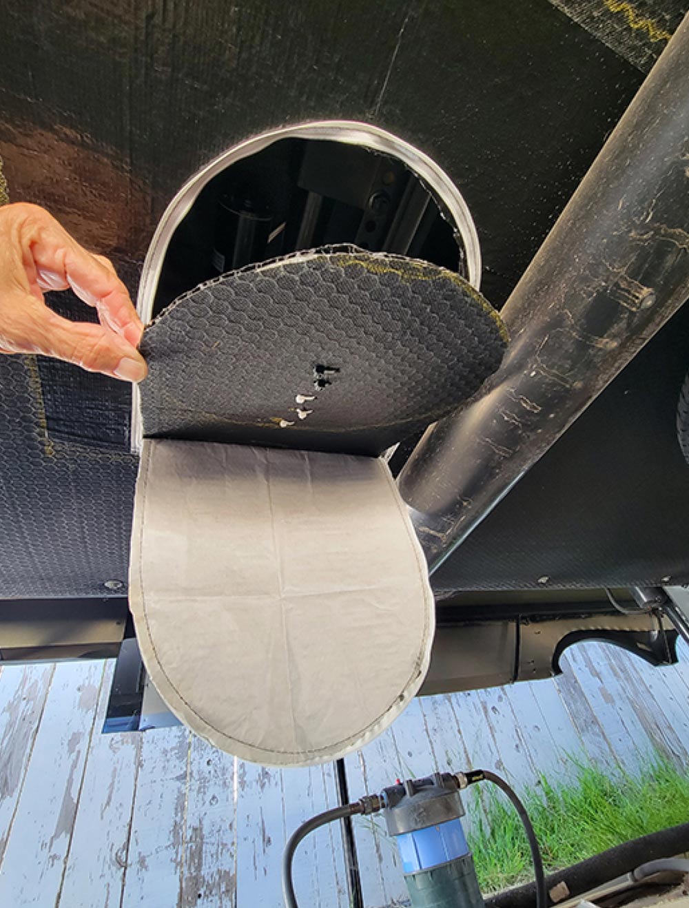 underbelly portion of a trap flap on the bottom of an RV