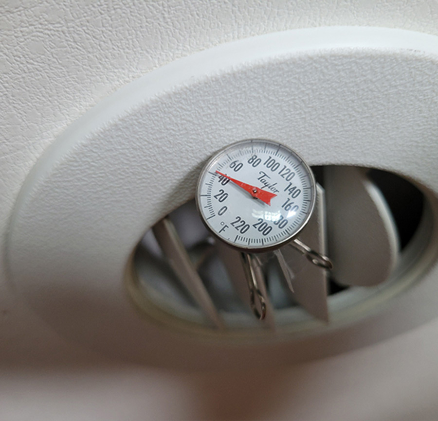 air conditioning thermometer inserted through a vent