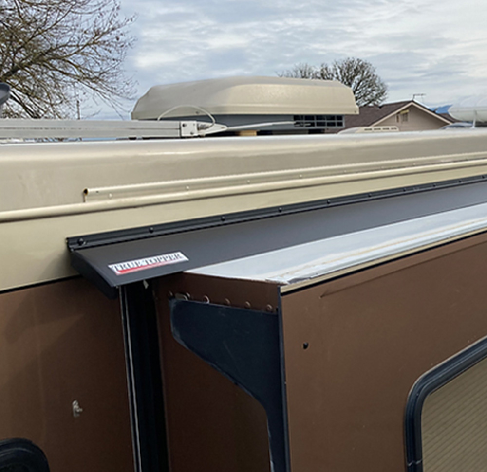 high angle view of a True Topper installed on a brown RV above a slide room