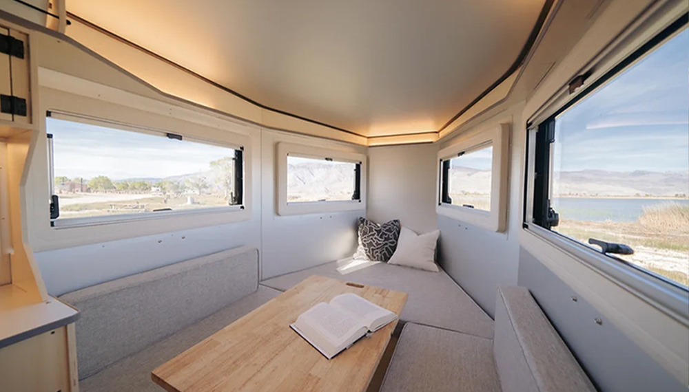 interior view of the new P21 trailer with a focus on the large windows around the lounge area and table