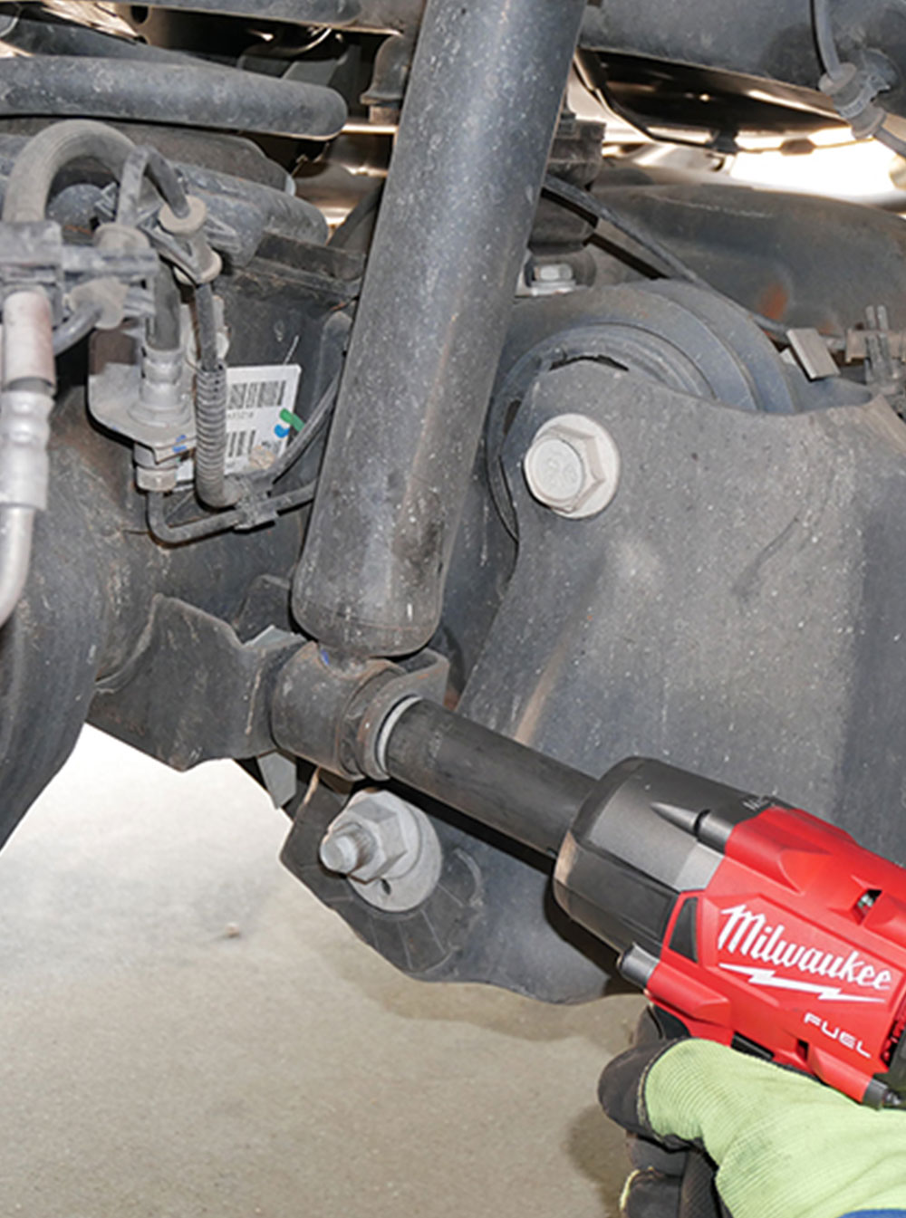 bottom bolt holding the old shock is loosened with a drill tool